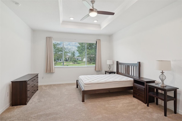 8932 SW 101st Cir, Ocala, FL 34481 - bedroom featuring a tray ceiling, light colored carpet, crown molding, baseboards, and a ceiling fan