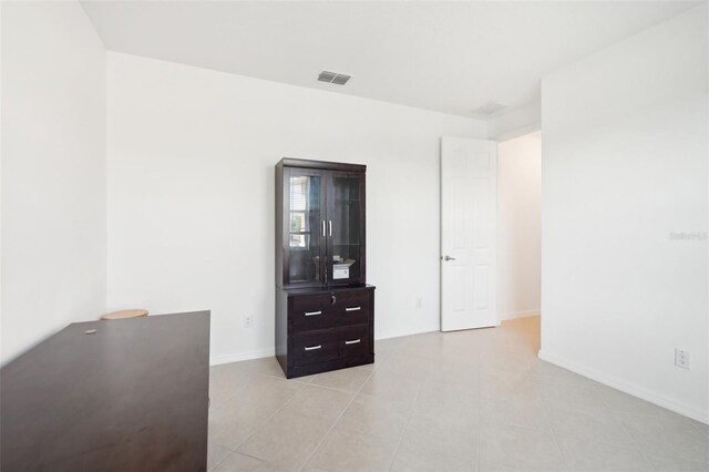 8932 SW 101st Cir, Ocala, FL 34481 - bedroom with baseboards and light tile patterned floors