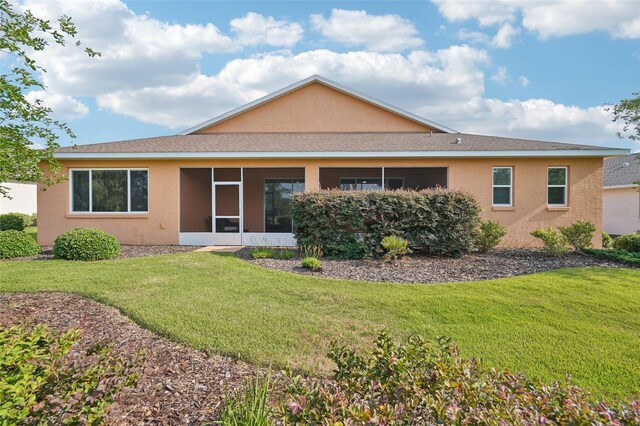 8932 SW 101st Cir, Ocala, FL 34481 - rear view of property with stucco siding, a lawn, a sunroom, and a shingled roof