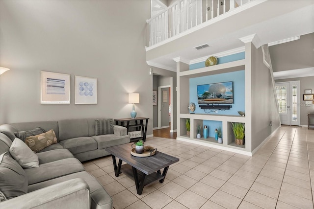 8522 Blue Horizon Ct, Kissimmee, FL 34747 - living area featuring a towering ceiling, light tile patterned floors, ornamental molding, and baseboards