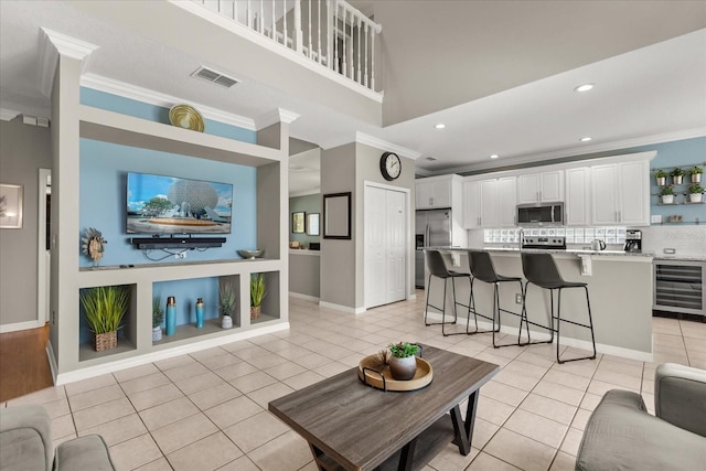 8522 Blue Horizon Ct, Kissimmee, FL 34747 - living area featuring wine cooler, crown molding, light tile patterned floors, recessed lighting, and baseboards