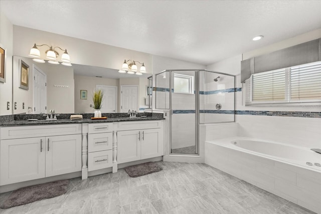 8522 Blue Horizon Ct, Kissimmee, FL 34747 - bathroom featuring a chandelier, a shower stall, a garden tub, and double vanity