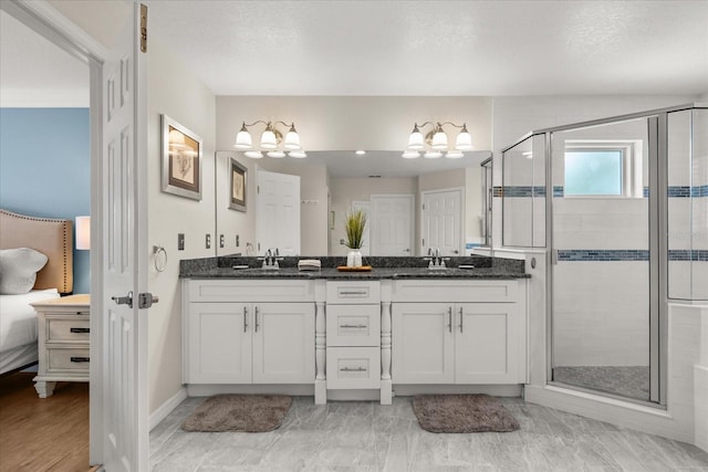 8522 Blue Horizon Ct, Kissimmee, FL 34747 - full bath featuring a chandelier, a shower stall, double vanity, and baseboards
