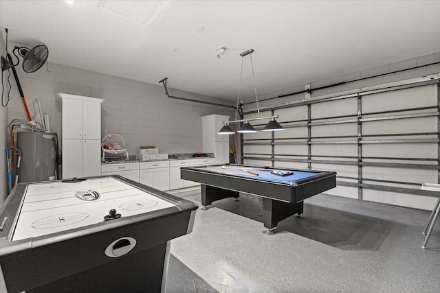 8522 Blue Horizon Ct, Kissimmee, FL 34747 - rec room featuring electric water heater, concrete block wall, pool table, and a garage