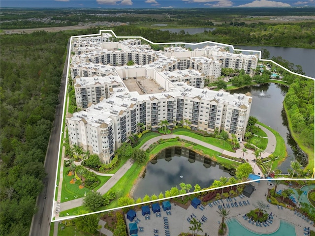 aerial overview of property's location featuring apartment complex, a nearby body of water, and property boundaries highlighted