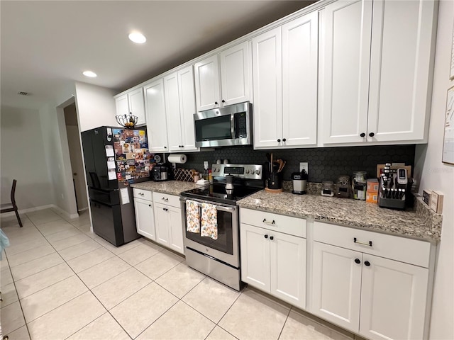 318 Briarbrook Ln, Haines City, FL 33844 - kitchen with appliances with stainless steel finishes, light tile patterned flooring, white cabinets, tasteful backsplash, and recessed lighting