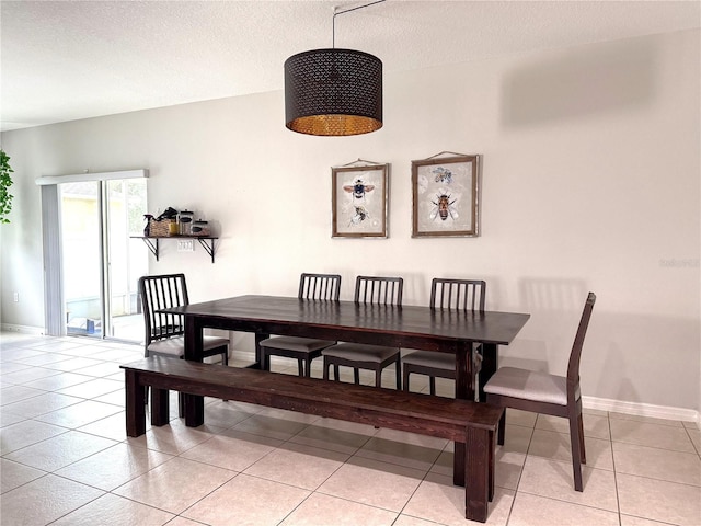 318 Briarbrook Ln, Haines City, FL 33844 - dining area with light tile patterned floors, baseboards, and a textured ceiling