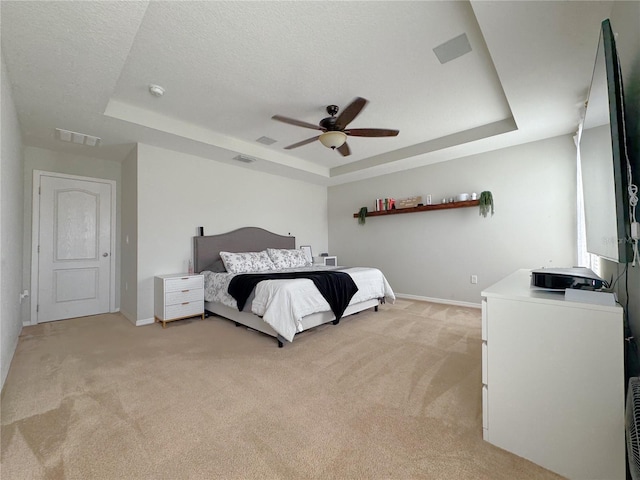 318 Briarbrook Ln, Haines City, FL 33844 - bedroom featuring a raised ceiling, light carpet, baseboards, and a textured ceiling