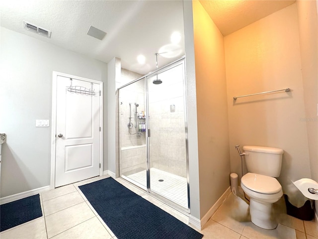318 Briarbrook Ln, Haines City, FL 33844 - full bathroom with tile patterned flooring, a stall shower, toilet, baseboards, and a textured ceiling