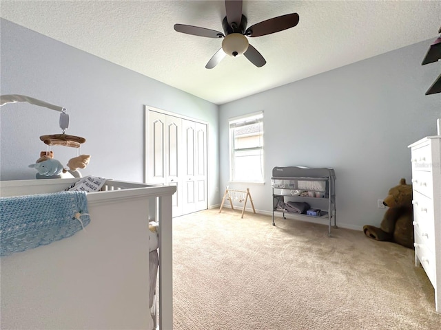 318 Briarbrook Ln, Haines City, FL 33844 - bedroom with light carpet, a closet, a textured ceiling, a ceiling fan, and baseboards