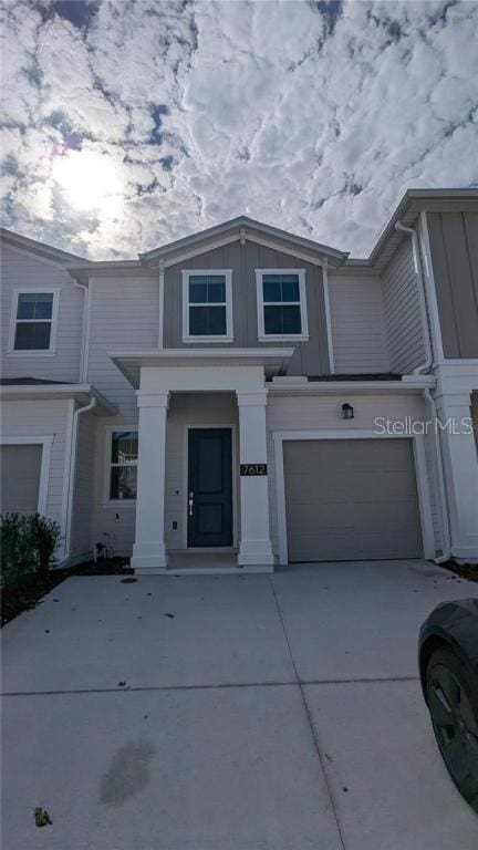7612 Danube Rd, Kissimmee, FL 34746 - view of property with a garage, concrete driveway, and board and batten siding