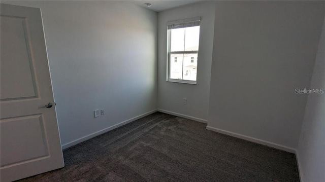 7612 Danube Rd, Kissimmee, FL 34746 - empty room featuring dark colored carpet and baseboards