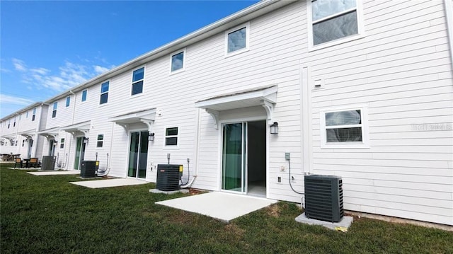 7612 Danube Rd, Kissimmee, FL 34746 - back of house featuring central air condition unit and a lawn