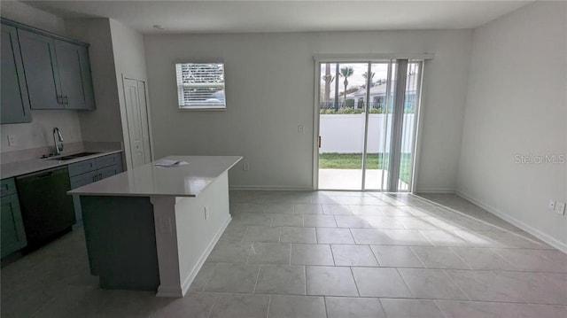 7612 Danube Rd, Kissimmee, FL 34746 - kitchen with a sink, black dishwasher, light countertops, a kitchen island, and light tile patterned floors