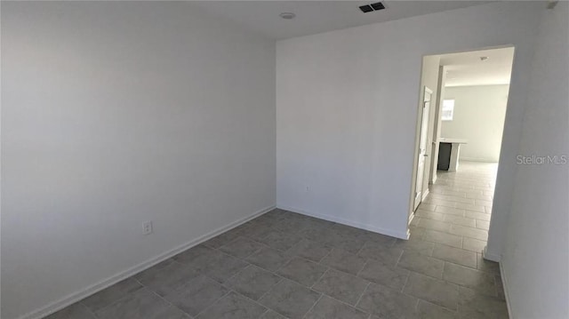 7612 Danube Rd, Kissimmee, FL 34746 - empty room featuring baseboards and dark tile patterned floors