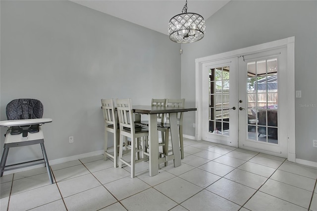 tiled dining room featuring french doors, baseboards, a chandelier, and vaulted ceiling