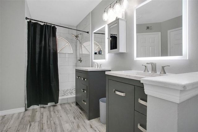 bathroom featuring a shower stall and vanity