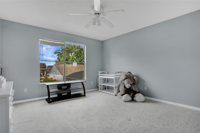 playroom with ceiling fan, baseboards, and carpet floors