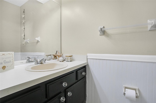 bathroom featuring a wainscoted wall and vanity