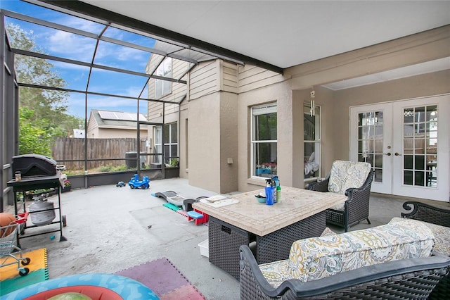 view of patio / terrace featuring french doors, outdoor dining area, and fence