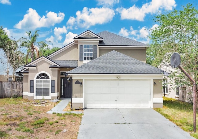 traditional home featuring roof with shingles, stucco siding, concrete driveway, an attached garage, and fence