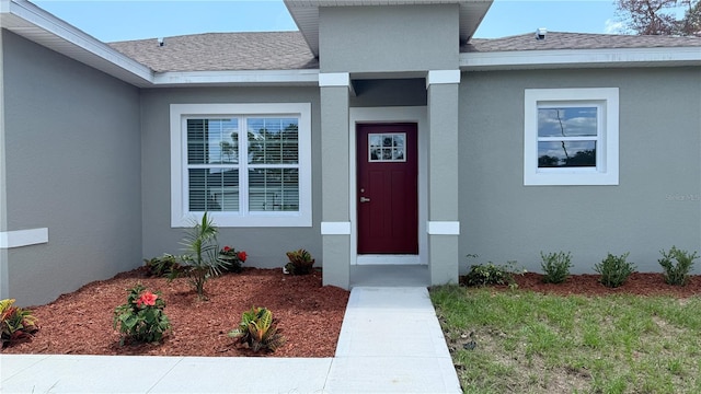 521 Marion Oaks Ln, Ocala, FL 34473 - property entrance with roof with shingles and stucco siding