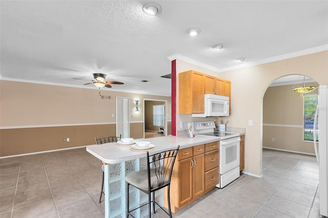 kitchen with white appliances, arched walkways, a ceiling fan, light tile patterned floors, and light countertops