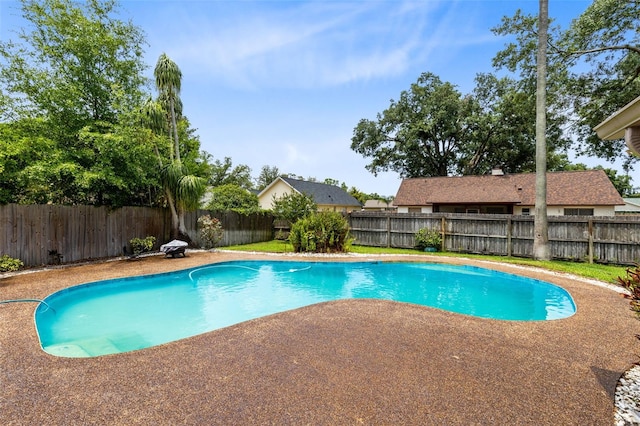 view of swimming pool featuring a fenced backyard and a patio
