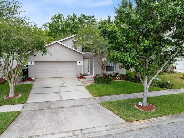 516 Brett Ct, Orlando, FL 32828 - view of front of house with driveway, an attached garage, a front yard, and stucco siding