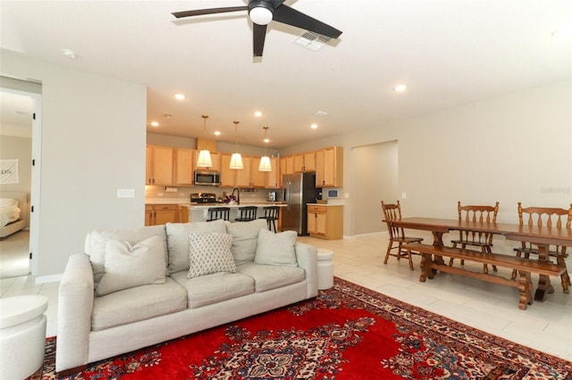 living area featuring ceiling fan, light tile patterned floors, recessed lighting, and baseboards