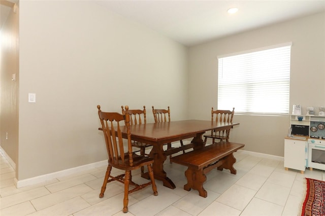 dining space with baseboards, recessed lighting, and light tile patterned flooring