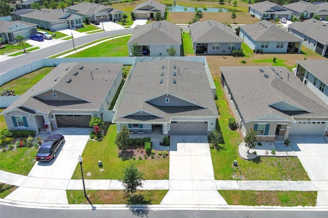 aerial perspective of suburban area with a nearby body of water