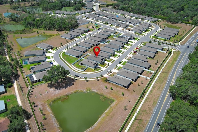 aerial overview of property's location with a large body of water and nearby suburban area