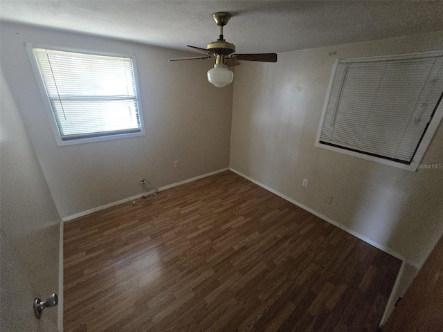 unfurnished room with wood finished floors, ceiling fan, and baseboards