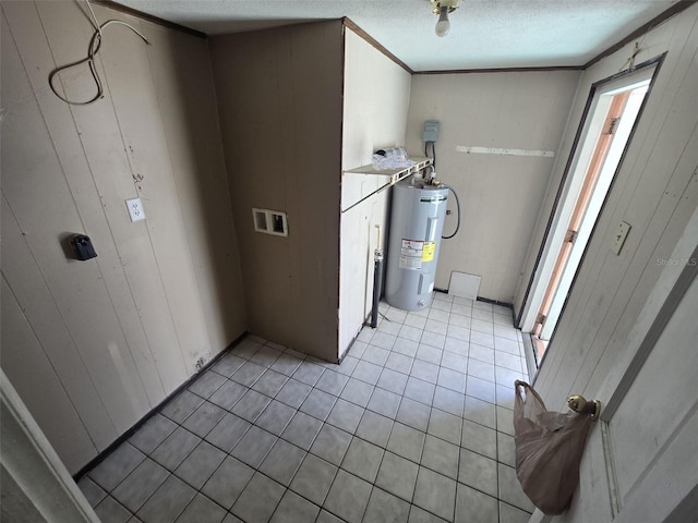 laundry room featuring water heater, light tile patterned floors, a textured ceiling, ornamental molding, and wooden walls