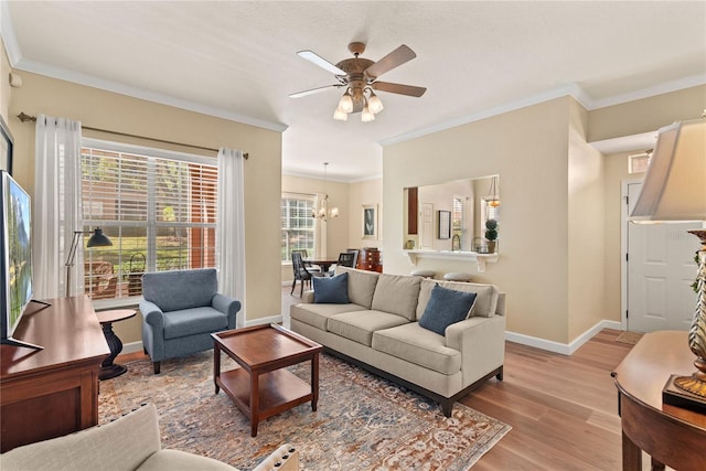 7628 Bay Port Rd Unit 43, Orlando, FL 32819 - living area featuring light wood finished floors, ornamental molding, baseboards, a chandelier, and ceiling fan