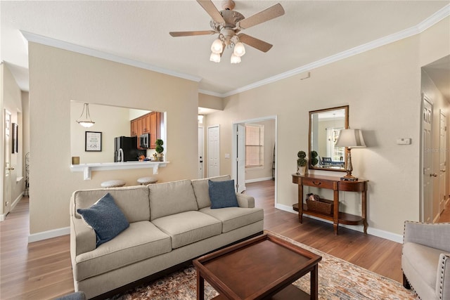 7628 Bay Port Rd Unit 43, Orlando, FL 32819 - living area with light wood-type flooring, ornamental molding, ceiling fan, and baseboards
