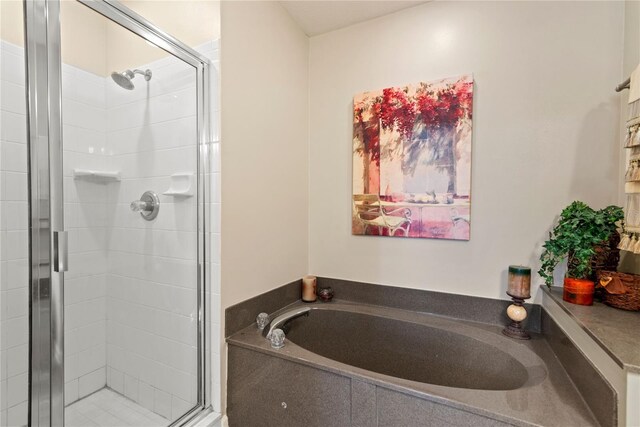 7628 Bay Port Rd Unit 43, Orlando, FL 32819 - bathroom featuring a shower stall and a bath