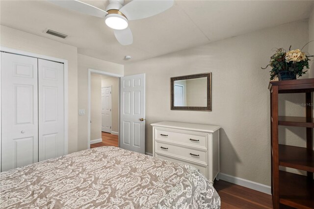 7628 Bay Port Rd Unit 43, Orlando, FL 32819 - bedroom featuring dark wood-style floors, a closet, baseboards, and a ceiling fan