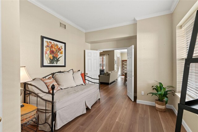 7628 Bay Port Rd Unit 43, Orlando, FL 32819 - sitting room featuring crown molding, wood finished floors, and baseboards
