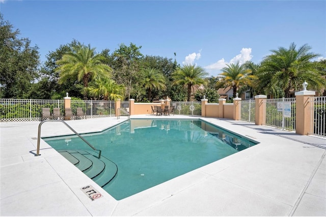7628 Bay Port Rd Unit 43, Orlando, FL 32819 - community pool featuring fence, a patio, and view of scattered trees