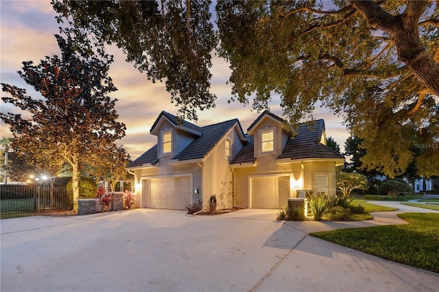 5025 Down Point Ln, Windermere, FL 34786 - traditional-style home featuring stucco siding, concrete driveway, a garage, and fence