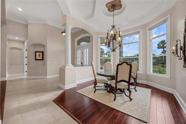 5025 Down Point Ln, Windermere, FL 34786 - dining area with ornate columns, a chandelier, baseboards, light wood-type flooring, and ornamental molding