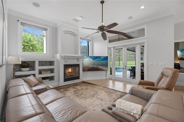 5025 Down Point Ln, Windermere, FL 34786 - living room featuring french doors, a glass covered fireplace, light tile patterned flooring, a ceiling fan, and baseboards