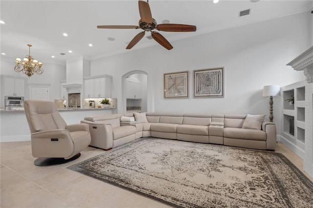 5025 Down Point Ln, Windermere, FL 34786 - living area with arched walkways, a ceiling fan, recessed lighting, light tile patterned floors, and a fireplace