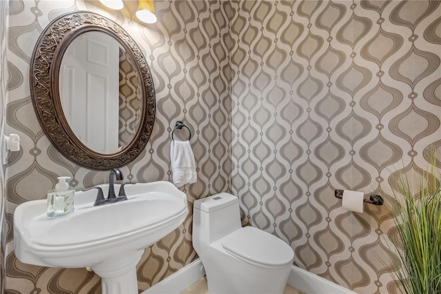5025 Down Point Ln, Windermere, FL 34786 - bathroom with wallpapered walls, toilet, and a sink
