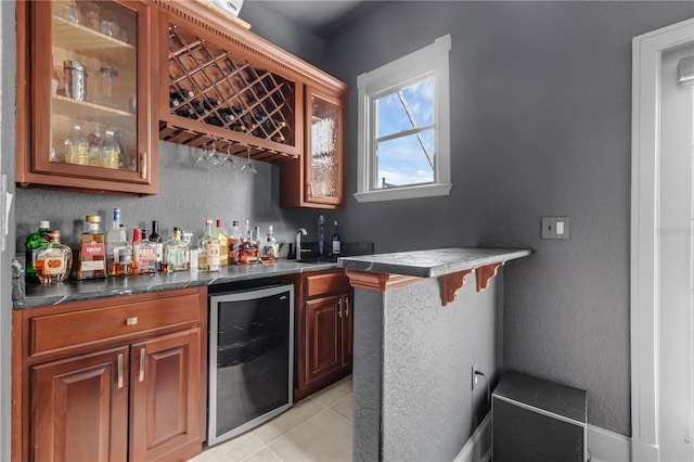 5025 Down Point Ln, Windermere, FL 34786 - indoor wet bar with beverage cooler, a textured wall, and light tile patterned flooring
