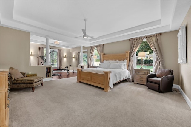 5025 Down Point Ln, Windermere, FL 34786 - bedroom featuring a raised ceiling, decorative columns, and light colored carpet