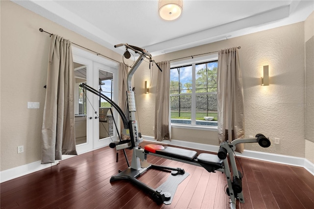 5025 Down Point Ln, Windermere, FL 34786 - workout area featuring a textured wall, baseboards, and wood finished floors