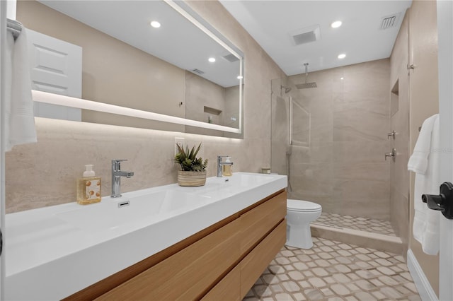 5025 Down Point Ln, Windermere, FL 34786 - full bath with recessed lighting, tiled shower, double vanity, tile walls, and toilet